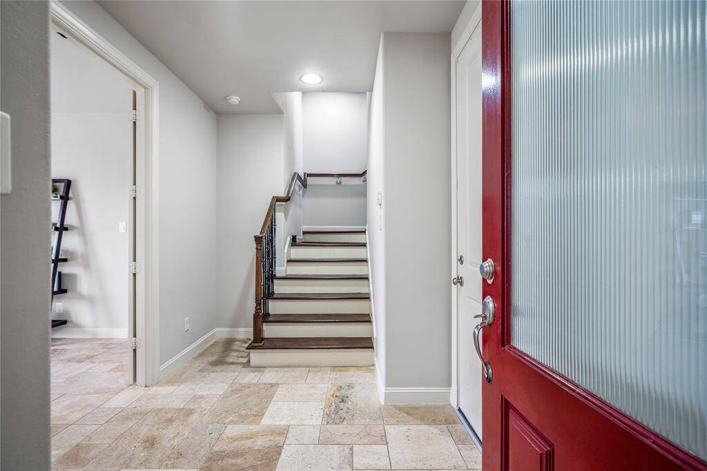 You are greeted by beautiful tile floors in the entry. A spacious first-floor bedroom is to the left. The door to the right is your entry to the garage.