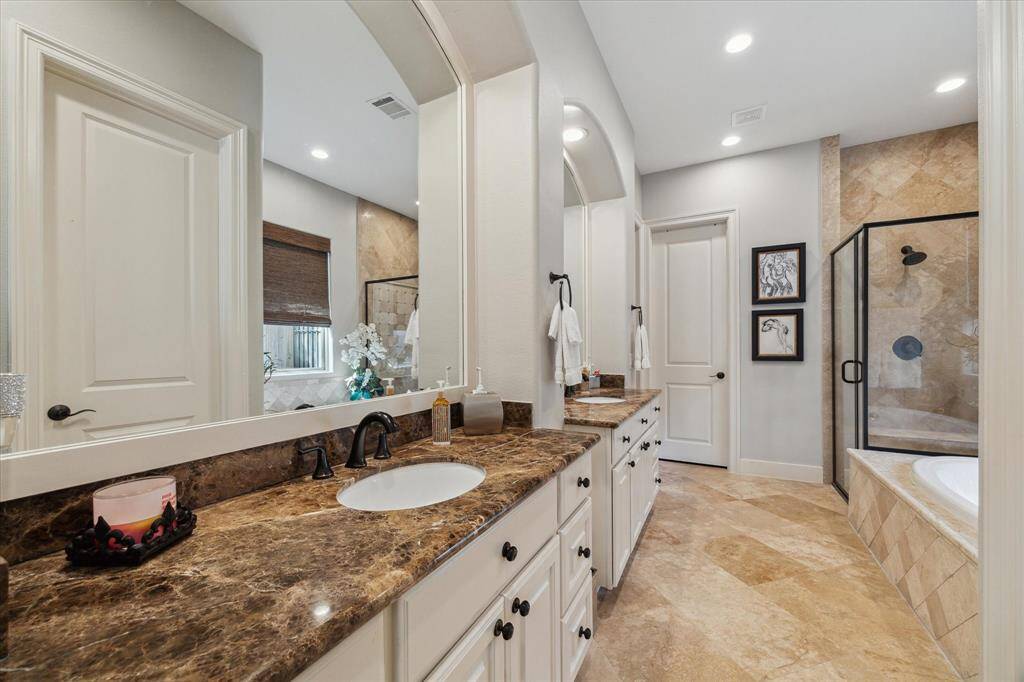 ELEGANT ENSUITE PRIMARY BATHROOM - dual vanities, arched openings above mirrors, jetted tub and separate shower