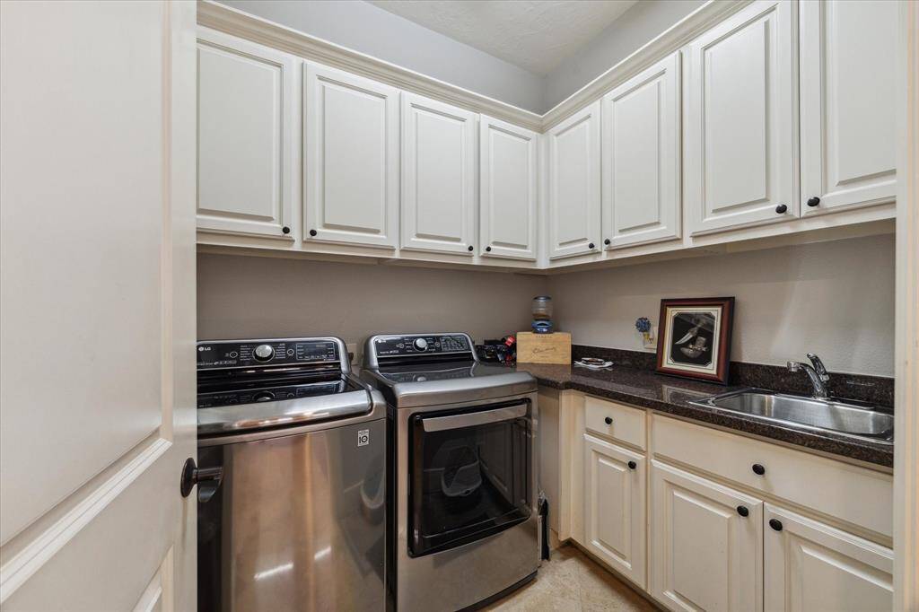 LARGE UTILITY ROOM WITH SINK - loads of cabinets for storage, good counter space - washer and dryer included