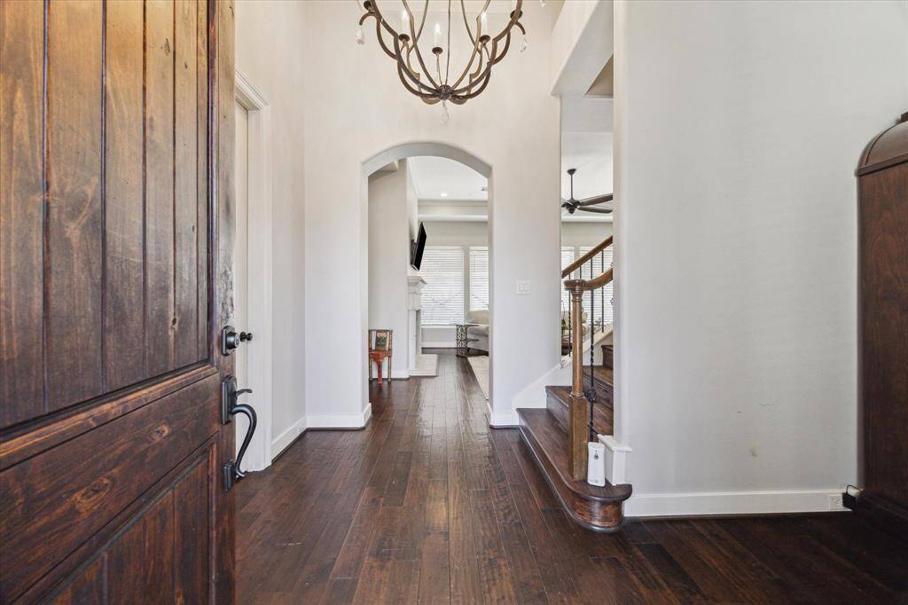 GRAND ENTRY TO THIS LOVELY HOME - handsome wood flooring and tall ceiling height, elegant chandelier