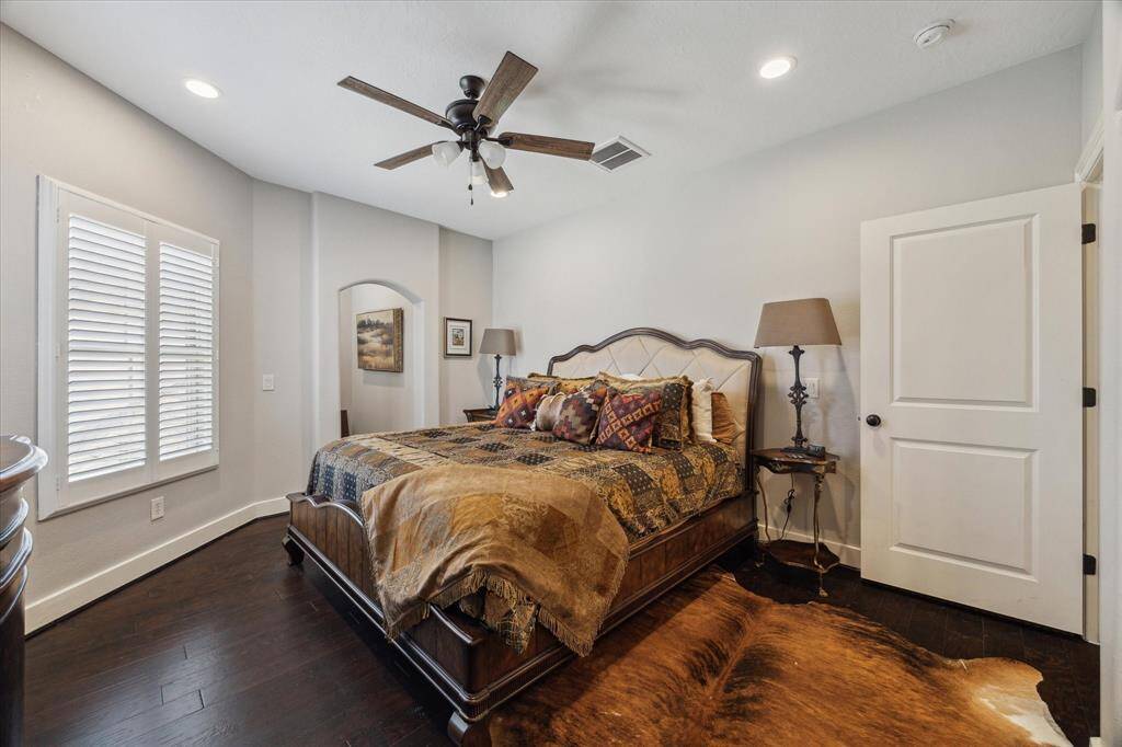 1 OF 2 SECONDARY BEDROOMS UPSTAIRS - wood flooring, neutral decor, recessed lighting and ceiling fan with lights, window overlooking the front - with walk-in closet, adjacent study alcove with built-in study area