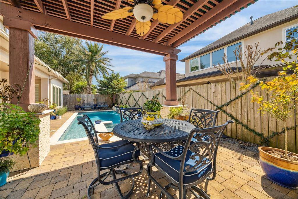 VIEW FROM THE RAISED TERRACE WITH PERGOLA - looking toward the pool and spa