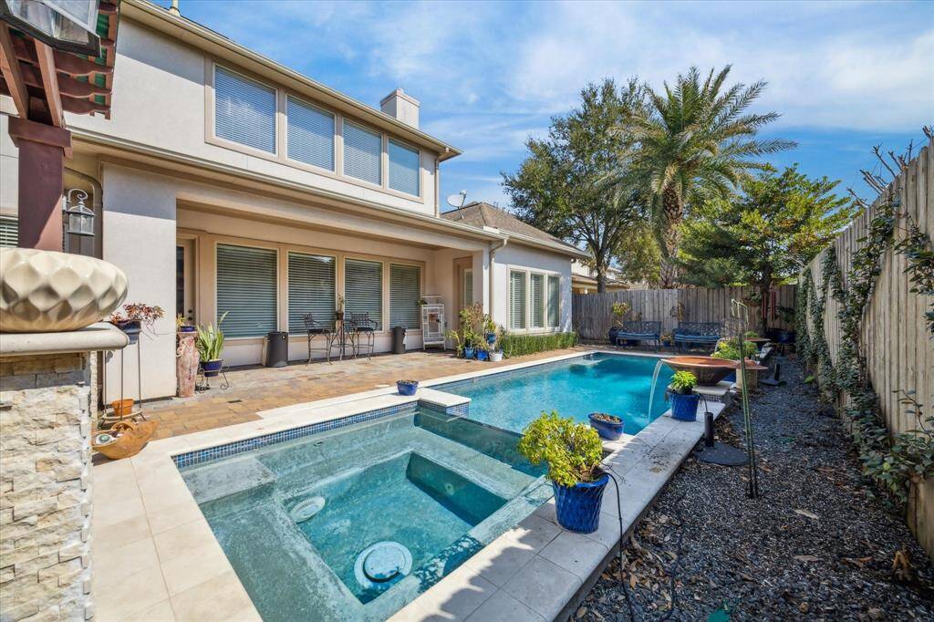 VIEW TOWARD THE HOME AND COVERED TERRACE FROM THE POOL AND SPA