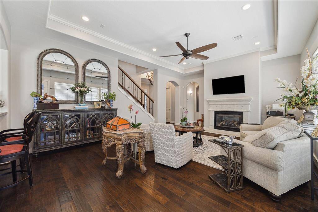 EASY ELEGANCE IN THE FAMILY ROOM - FIREPLACE WITH CAST STONE SURROUND - neutral decor, handsome wood flooring
