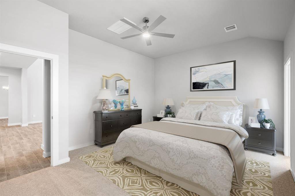 Indulge in relaxation in the magnificent primary suite following a busy day! This roomy haven showcases plush carpet, inviting paint colors, high ceilings, and generous windows with privacy blinds. Sample photo of completed home with similar floor plan. Actual colors and selections may vary.
