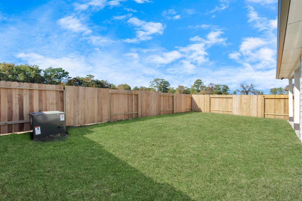 Discover the charm of this spacious backyard featuring a delightful covered patio. With ample room for both play and relaxation, it's the perfect outdoor haven. Tailor this space to your liking with patio furniture, a BBQ pit, and more. The potential for creating your dream outdoor living area is limitless! Sample photo of completed home with similar floor plan. Actual colors and selections may vary.
