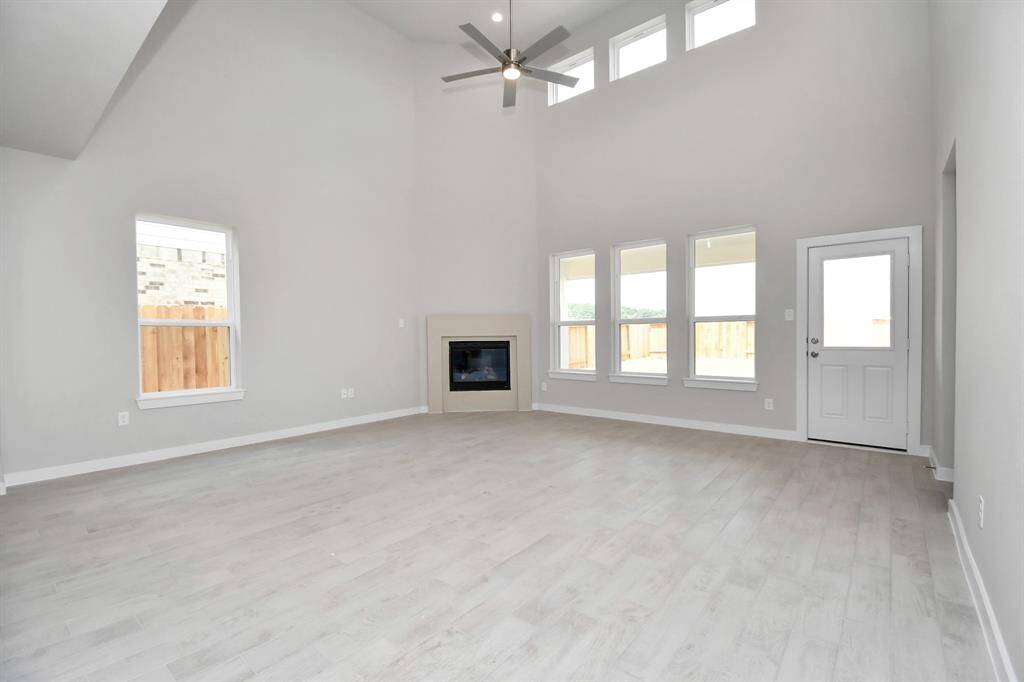 Take another glimpse into the heart of the home with this additional view of the family room—a sprawling space ready to accommodate all your gatherings. Sample photo of completed home with similar floor plan. Actual colors and selections may vary.