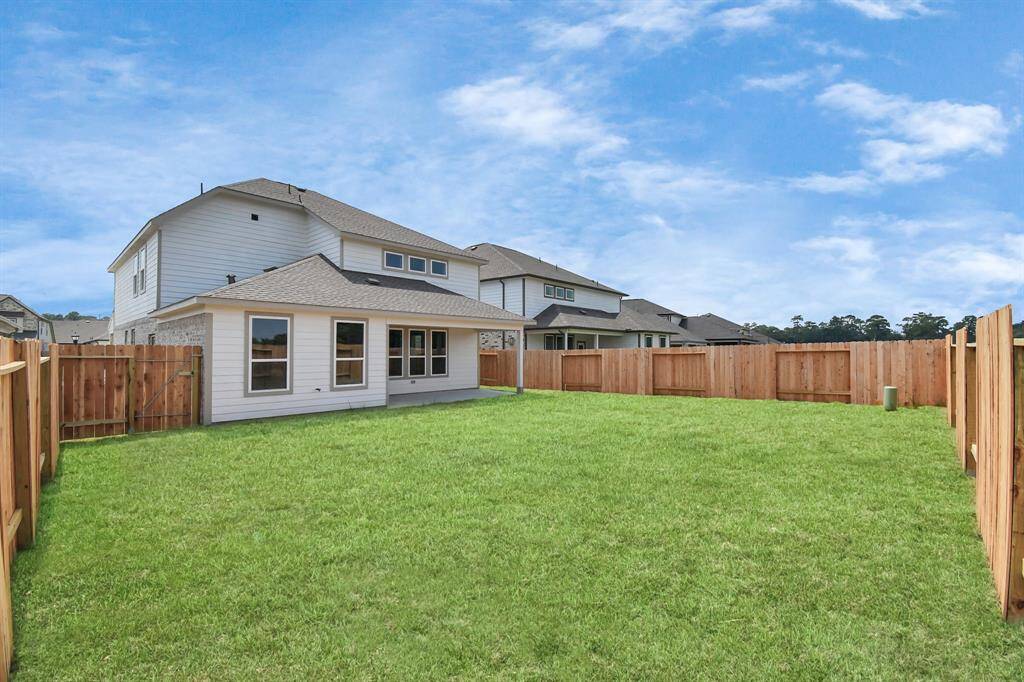 Step into a world of outdoor possibilities with this remarkable backyard and its charming covered patio. From playtime for the kids to relaxation for the adults, this space offers the best of both worlds. Sample photo of completed home with similar floor plan. Actual colors and selections may vary.