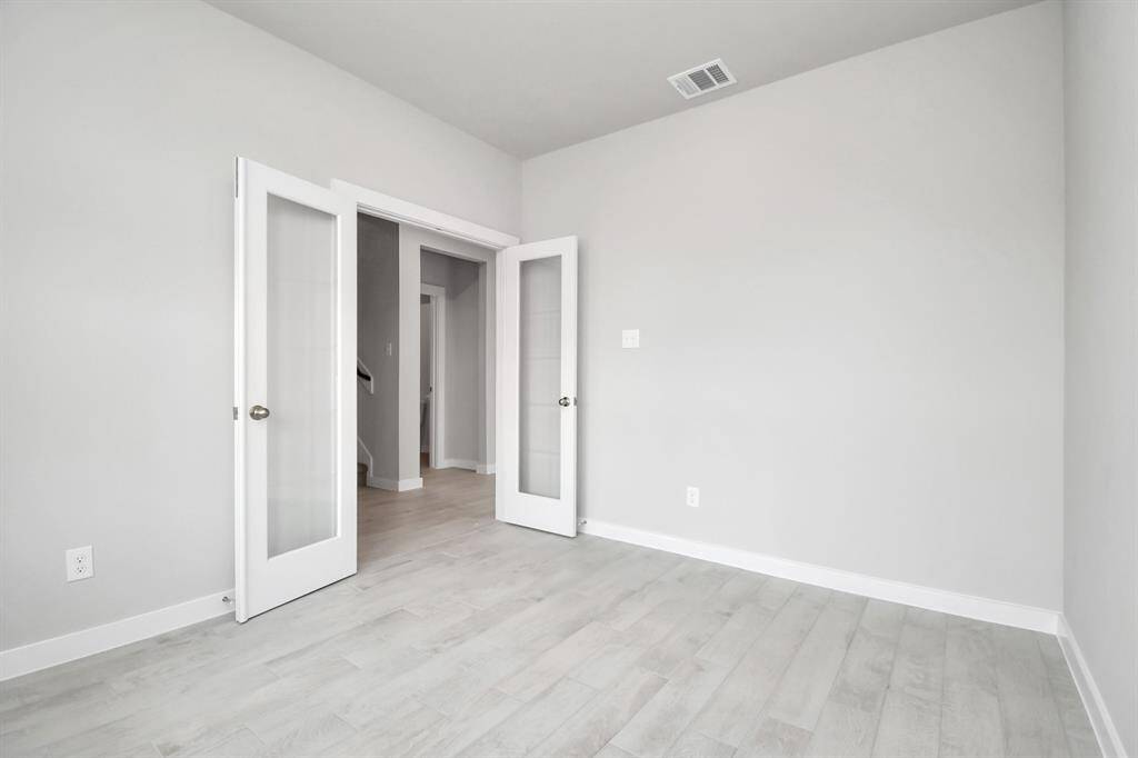 Another view of the home office with French doors. Sample photo of completed home with similar floor plan. Actual colors and selections may vary.