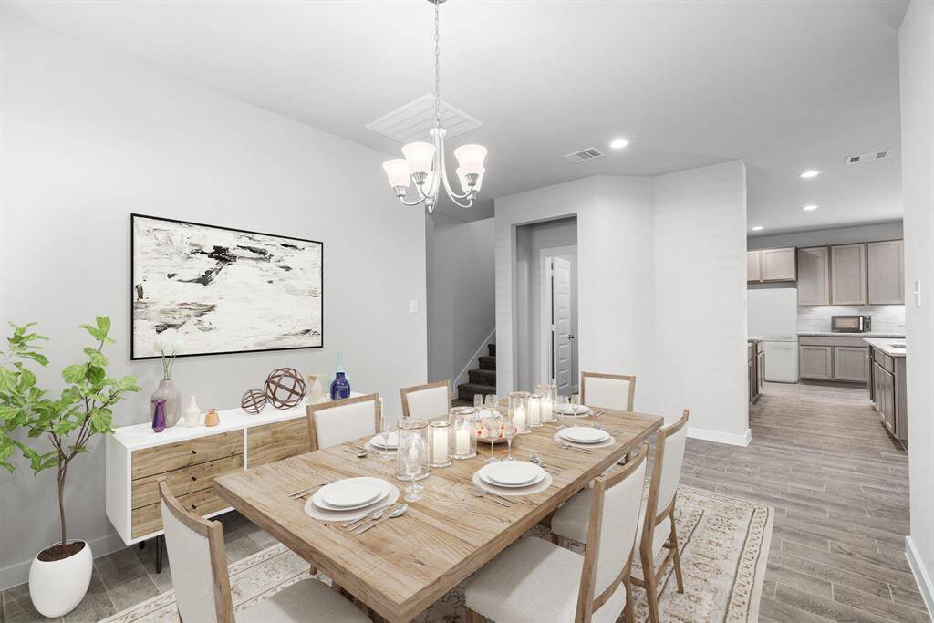 Make memories gathered around the table with your family and friends! This dining spacious room features elegant flooring, custom paint, and adjacent to family room and kitchen for open concept feel. Virtual Staged. Sample photo of completed home with similar floor plan. Actual colors and selections may vary.