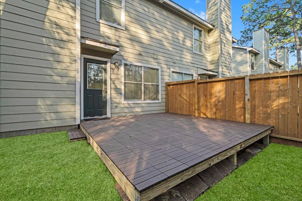 The cozy backyard features a newly constructed wooden deck, enclosed by a wooden fence. No back neighbors offering a private and inviting outdoor space.