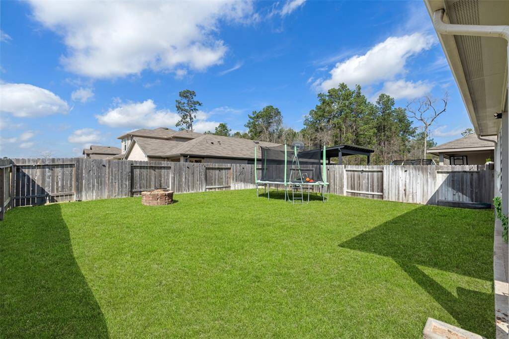 Back yard/Corner lot. Firepit and trampoline convey with home( grass is enhanced)