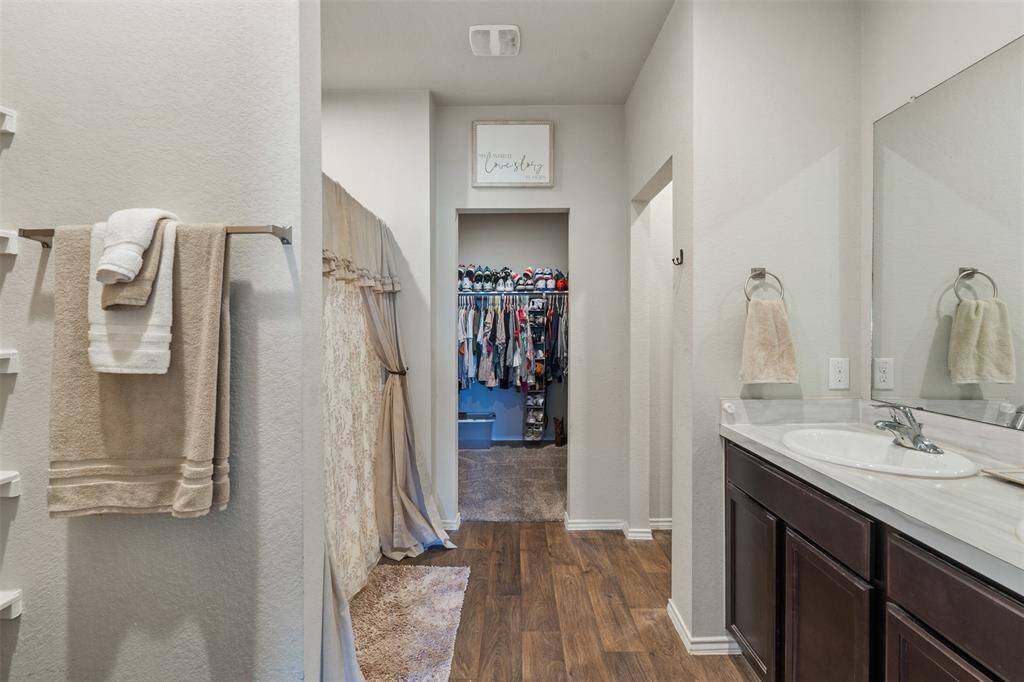 Primary bath with double sinks and walk in closet