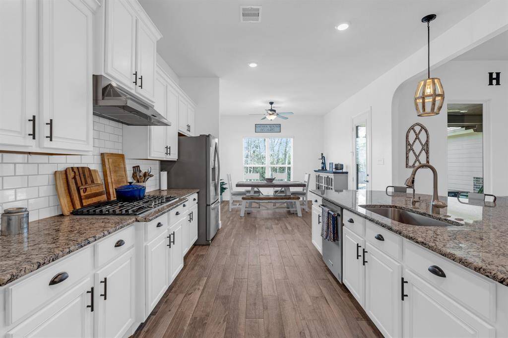 The generous island provides additional workspace and seating, perfect for casual meals or entertaining guests.