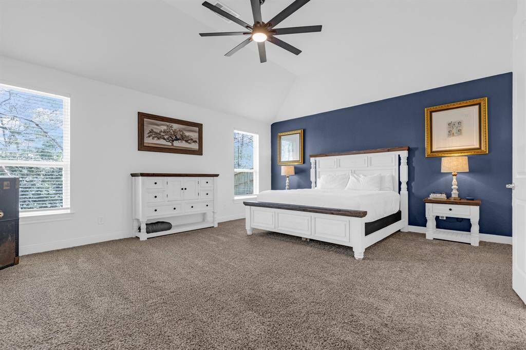 Welcome to the serene primary bedroom, a spacious retreat designed for relaxation and comfort. The room features custom shiplap walls that add a touch of rustic elegance, creating a cozy yet sophisticated atmosphere.