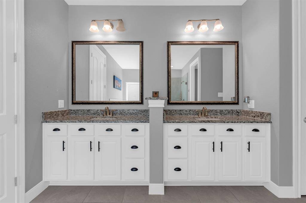 This beautifully designed space features a double vanity, offering both convenience and style.