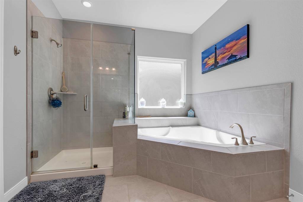 This spacious bathroom features a large soaking tub, perfect for unwinding after a long day.
