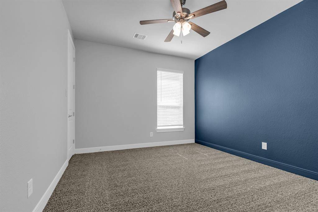 One of three secondary bedrooms; this room features generous dimensions that can accommodate various furniture layouts, allowing for personalization and comfort.
