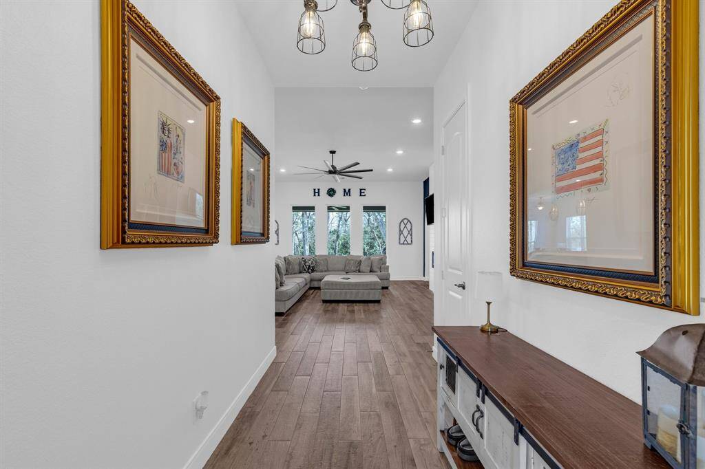 Step into this inviting home where the front entryway seamlessly opens into a spacious and airy living area.