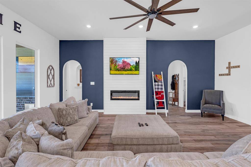 Adding warmth and charm to the living area is a sleek electronic fireplace, a modern focal point that provides both ambiance and comfort.