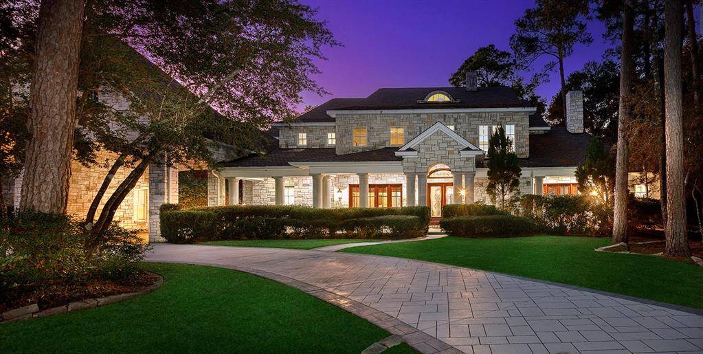 Gorgeous stone elevation, this custom home faces a serene pond and features a circular driveway and solar roof panels for energy efficiency