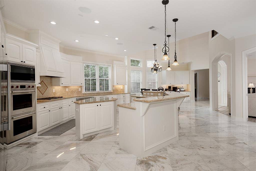 The light filled open concept kitchen/breakfast/family room offers so much storage space, and a walk-in pantry