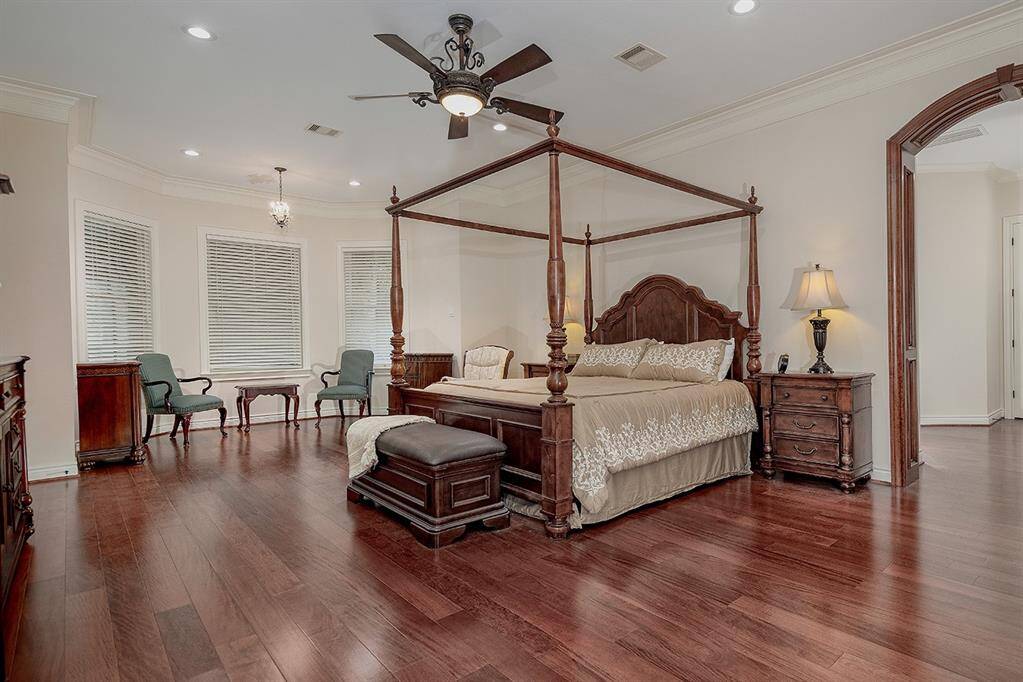 Secluded owner's retreat with sitting area and beautiful hardwood flooring