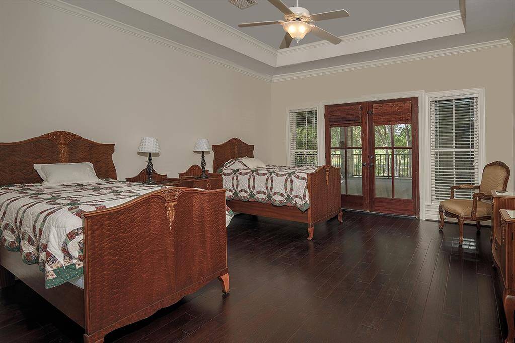 Another guest bedroom with en-suite bath, walk in closet and balcony - and no carpet!
