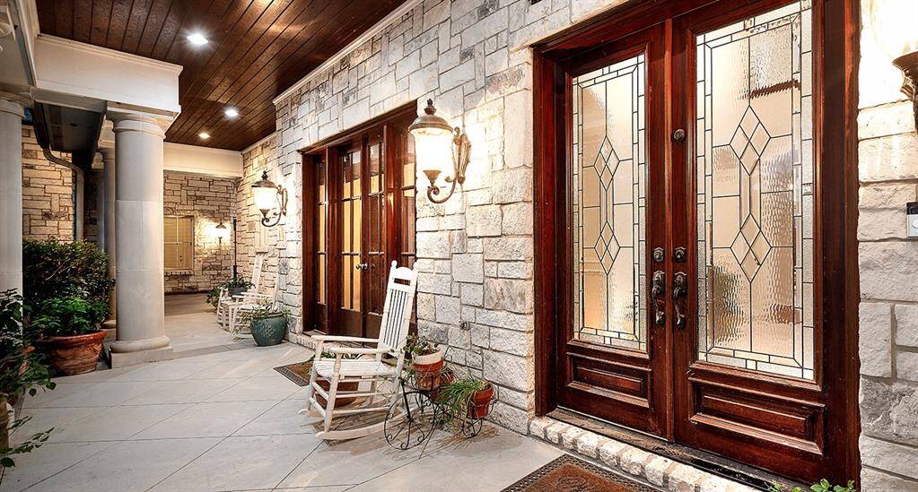Extensive covered front porch with stained wood ceiling
