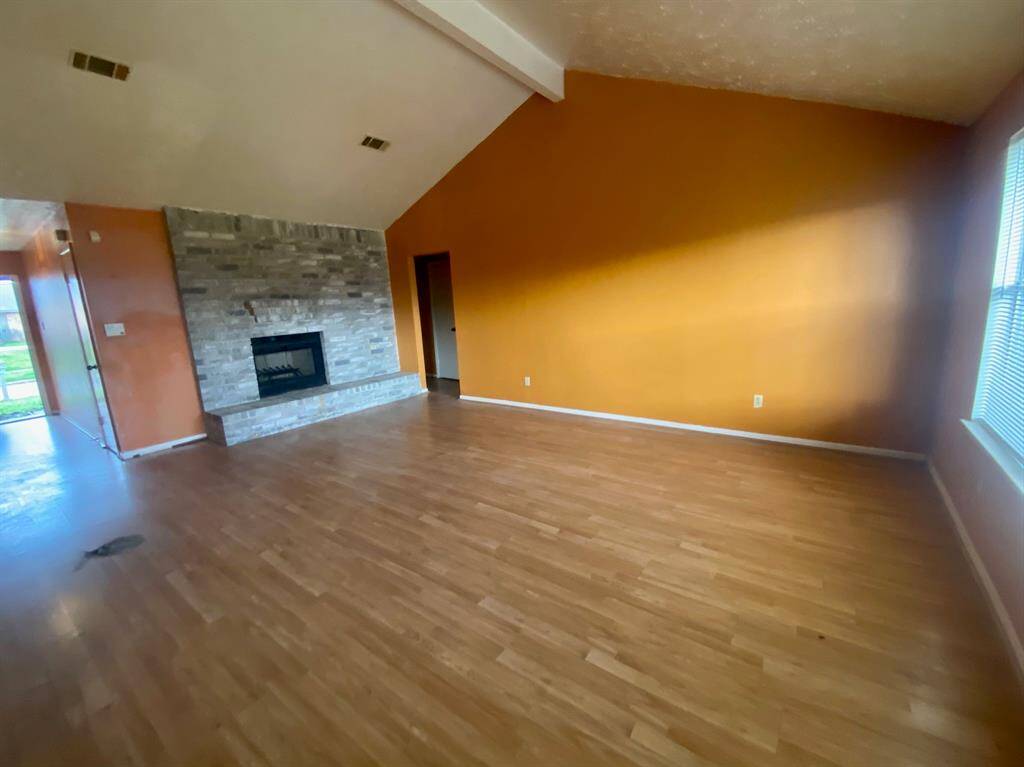 Brick accented wood burning fireplace