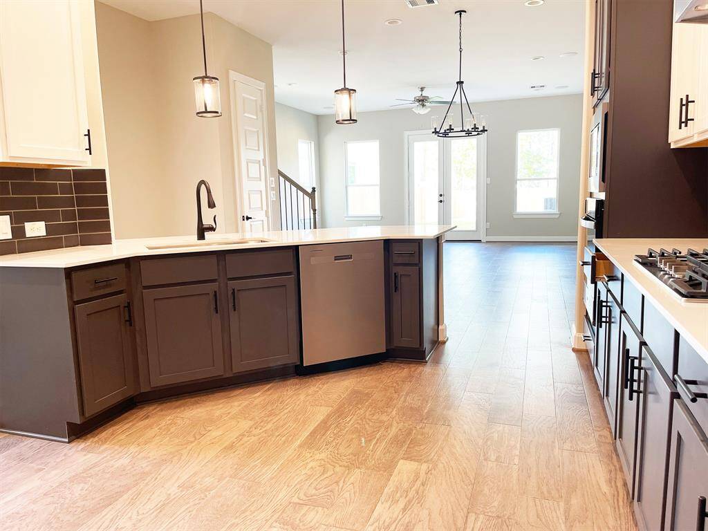 Oversized countertops, phenomenal lighting and open concept design. *Image depicts home as-is virtually staged.