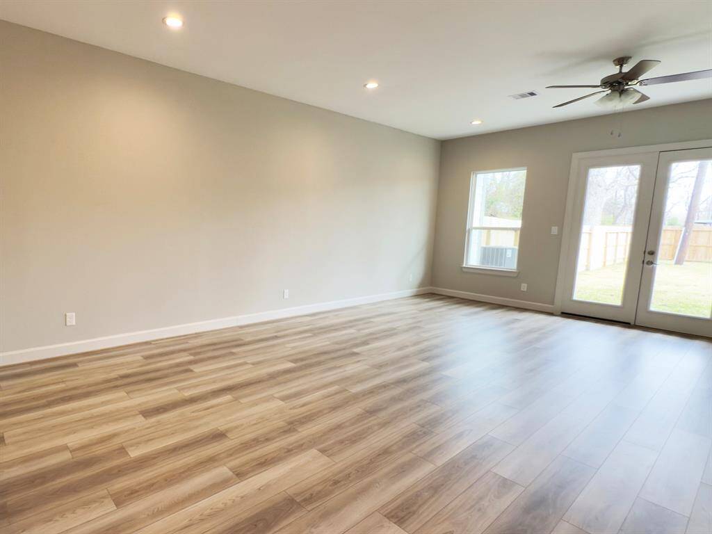 Seamlessly connected dining and living spaces with elegant finishes, embodying the signature style of ROC Homes. Image home as-is.