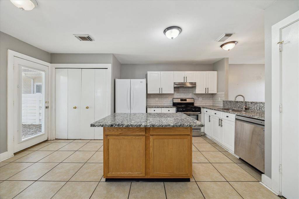 Ditch the takeout and cook from home more often! This spacious island kitchen offers plenty of countertop space for easy meal prep and clean up. With a large pantry, ample cabinetry, and convenient utility area, you'll have plenty of room for all your favorite kitchen gadgets here.