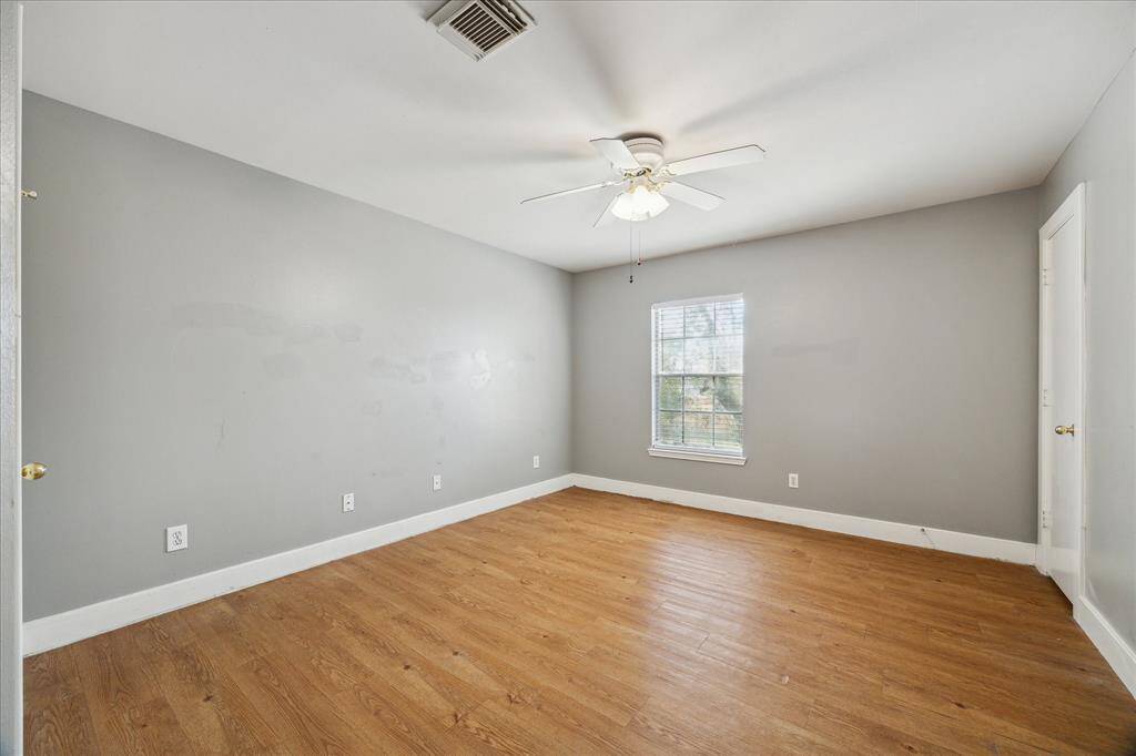 There are three spacious bedrooms, including this inviting primary suite with durable wood laminate flooring, neutral paint, two closets and easy access to a full bathroom.