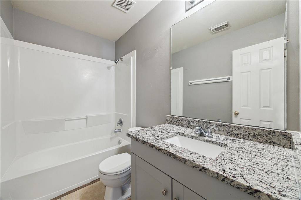 The updated full bathroom upstairs offers a granite vanity with an under-mount sink, full mirror and vanity lights above while a convenient tub/shower enclosure completes the space.