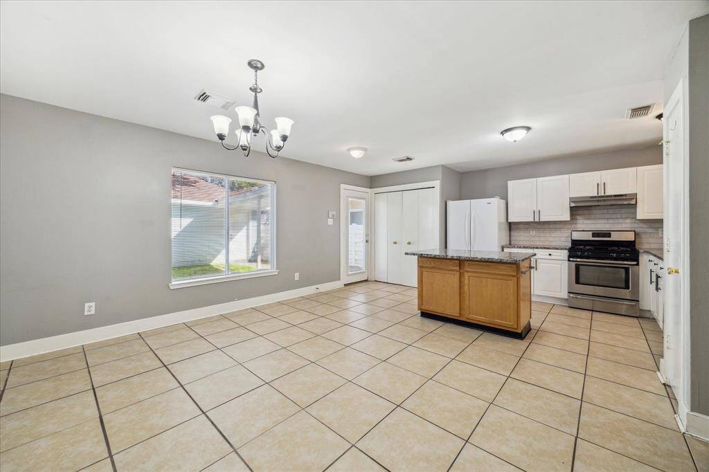An open, elegant formal dining room provides the ideal space to host your next special occasion. With tile flooring, neutral paint, and a stylish chandelier, you'll love breaking bread in this lovely space.