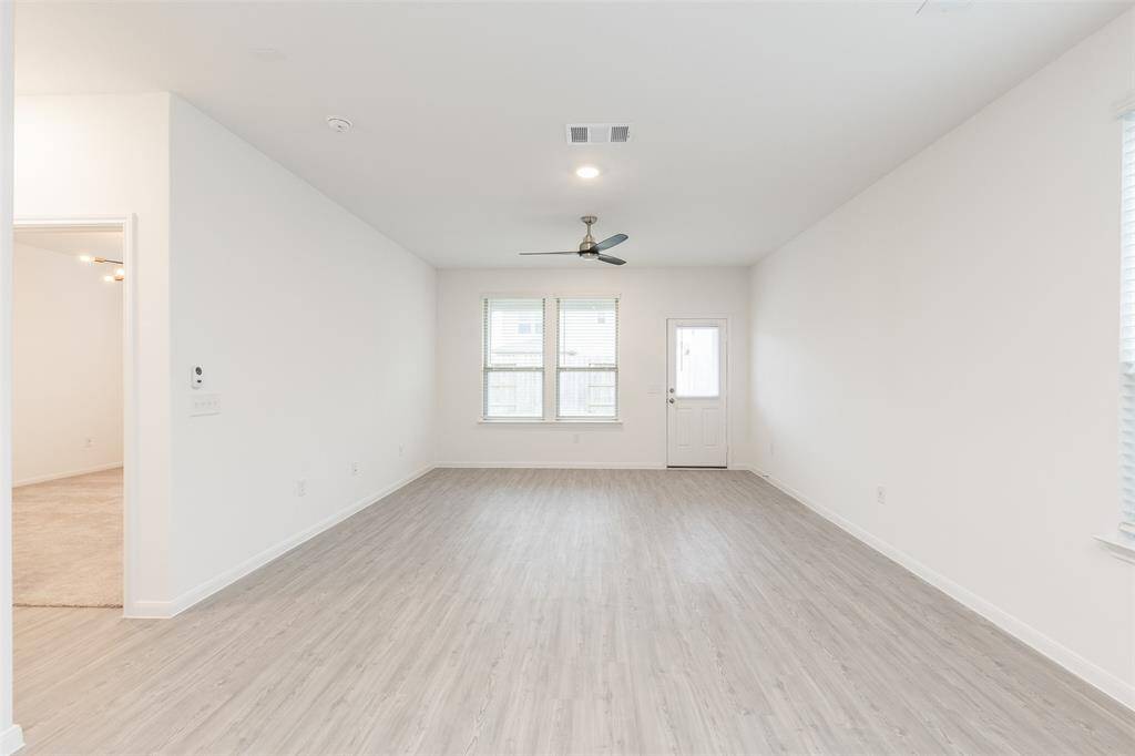 Another view of the living room. To the left is primary bedroom.