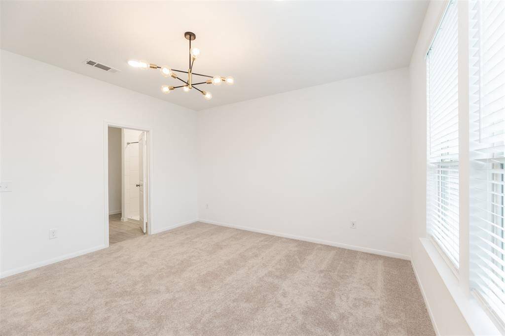 View of the primary bedroom. To the left is the primary bathroom.