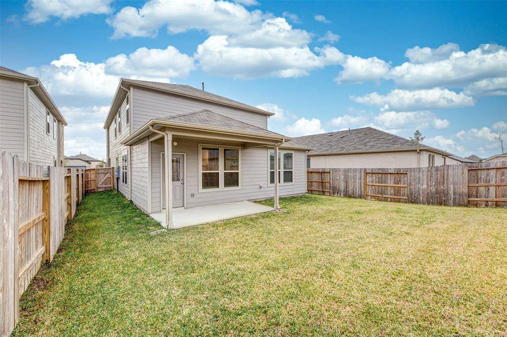 View of the backyard and covered patio.