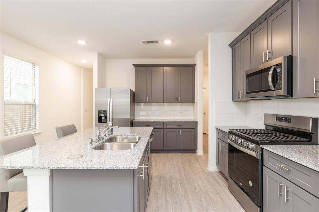This amazing kitchen also has soft close cabinets and pop up counter top outlets.