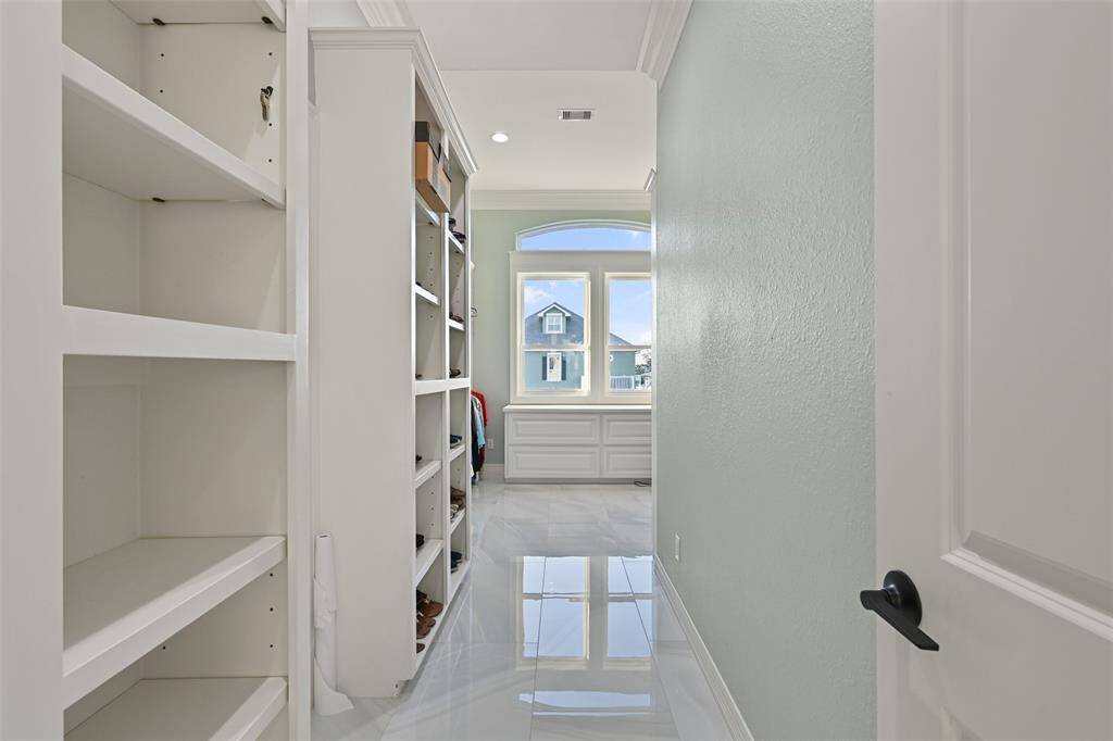 Oversized walk in closet with lots of built-ins