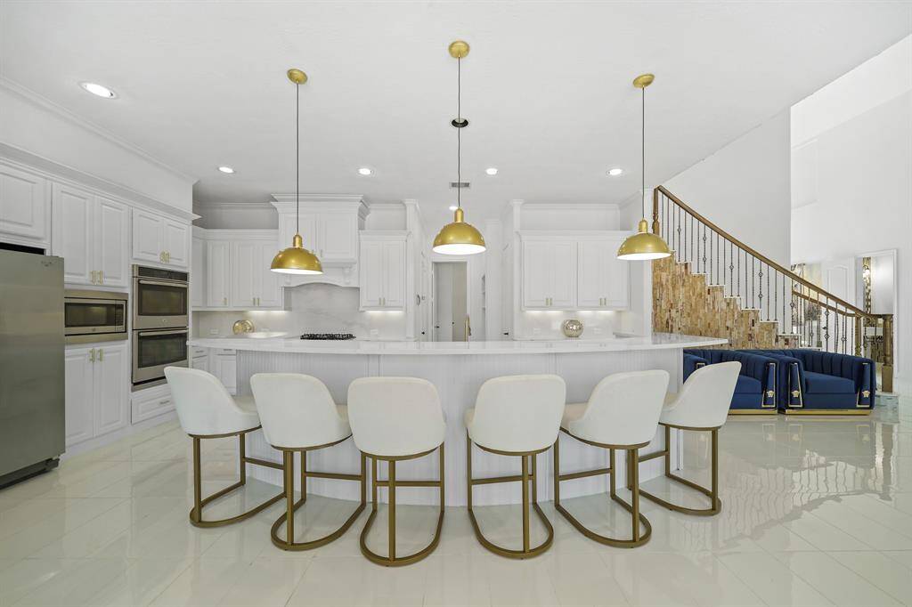 The counter provides ample seating for up to 8-10 people on bar stools, making it both a stunning and a perfect gathering spot.