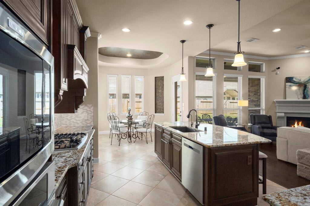 Open to the family room, with ample counter space and a deep pantry for storage.