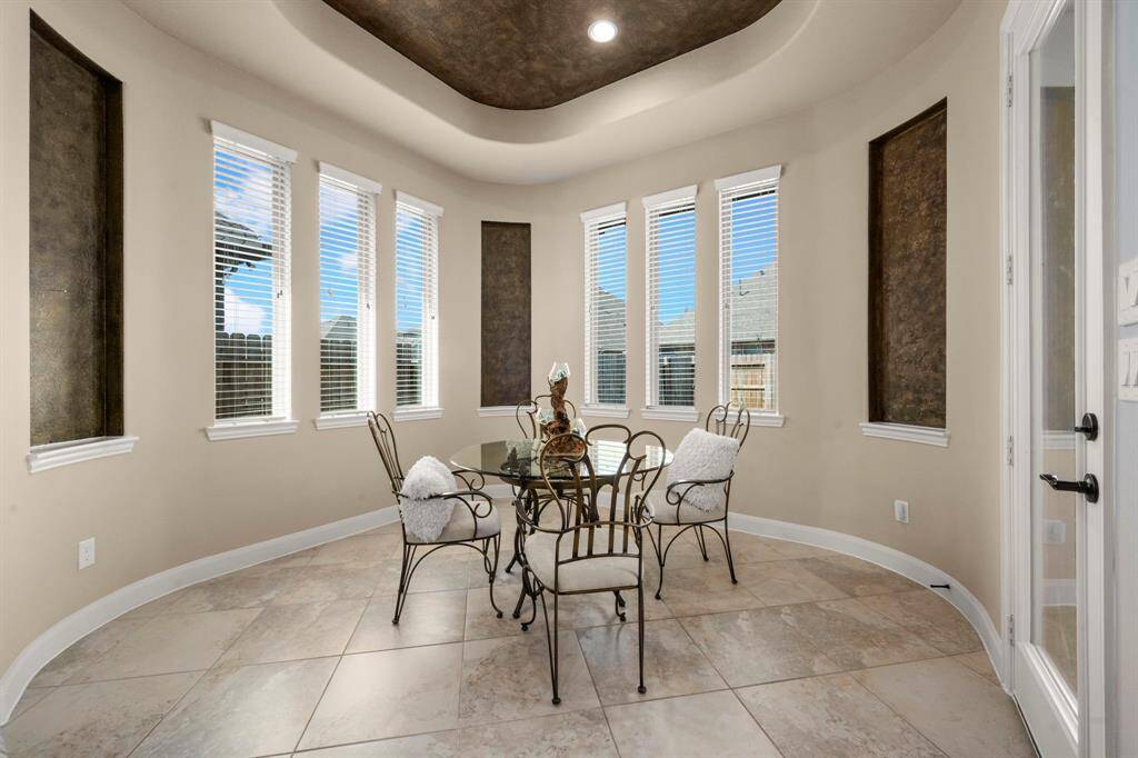 The rotunda breakfast area is perfect for your mornings, cozy yet spacious, ideal for enjoying coffee with a backyard view.