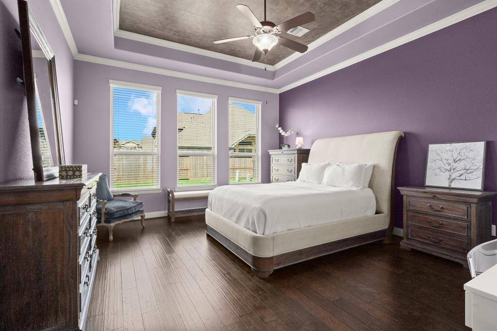 Expansive windows flood the room with natural light, offering serene backyard views that make every morning feel like a retreat.
