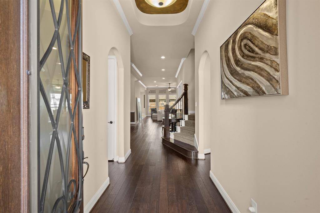 A formal entryway sets the stage with soaring ceilings and elegant finishes.