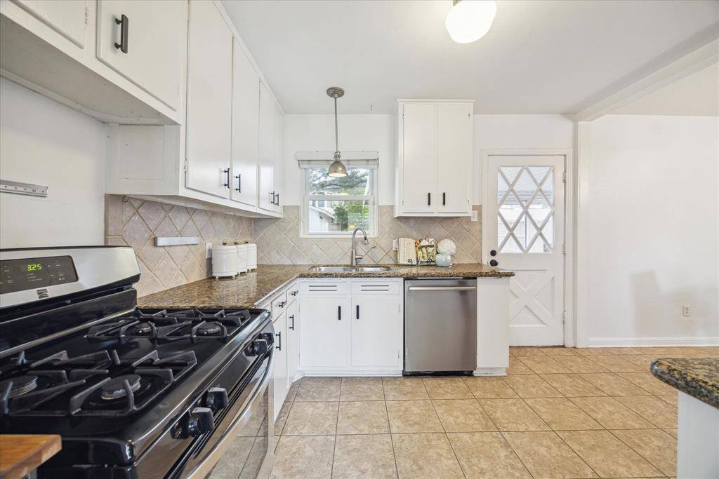 Another view of the kitchen. The door leads to the screened in porch and backyard.
