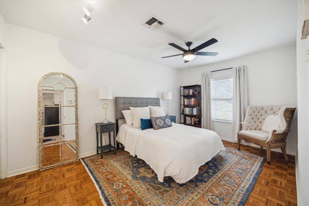 The large primary bedroom provides lots of space and natural light. It can easily fit a king-sized bed, even though a queen is pictured.