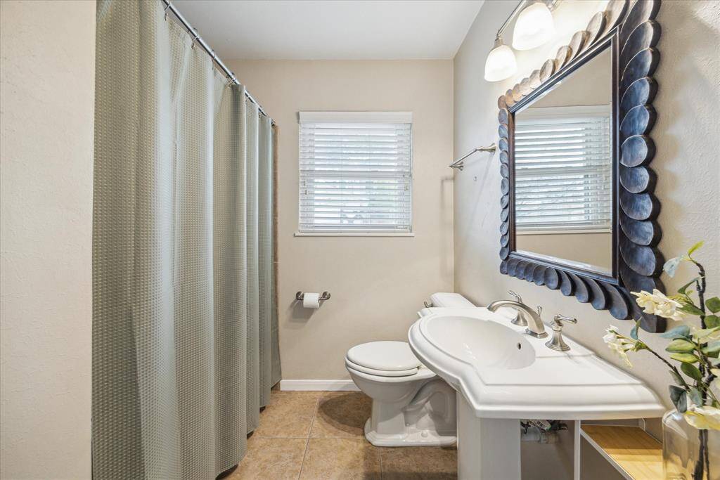 Secondary Bathroom is located off the hallway. It is shared with the 2 secondary bedrooms as well as guests! There is a shower/tub combo & linen closet.