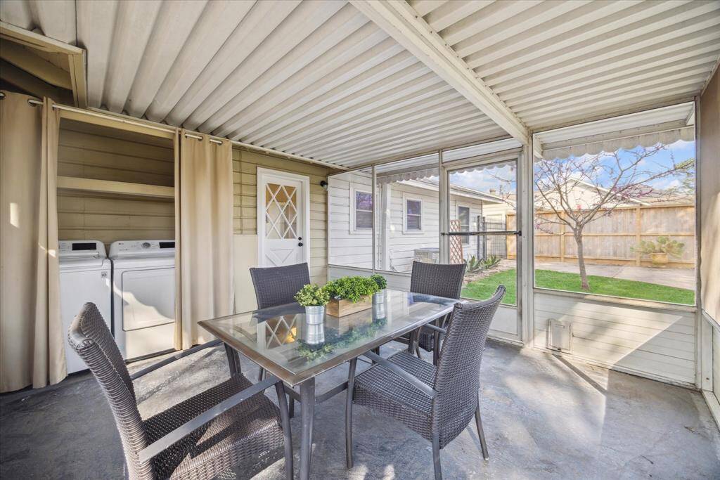 Another beautiful view of the screened in porch. This is also where the laundry room is located (washer & dryer convey with home).